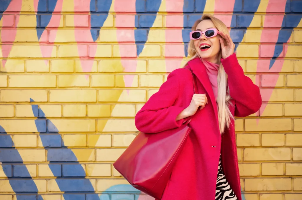 woman in pink coat, purse, and sunglasses